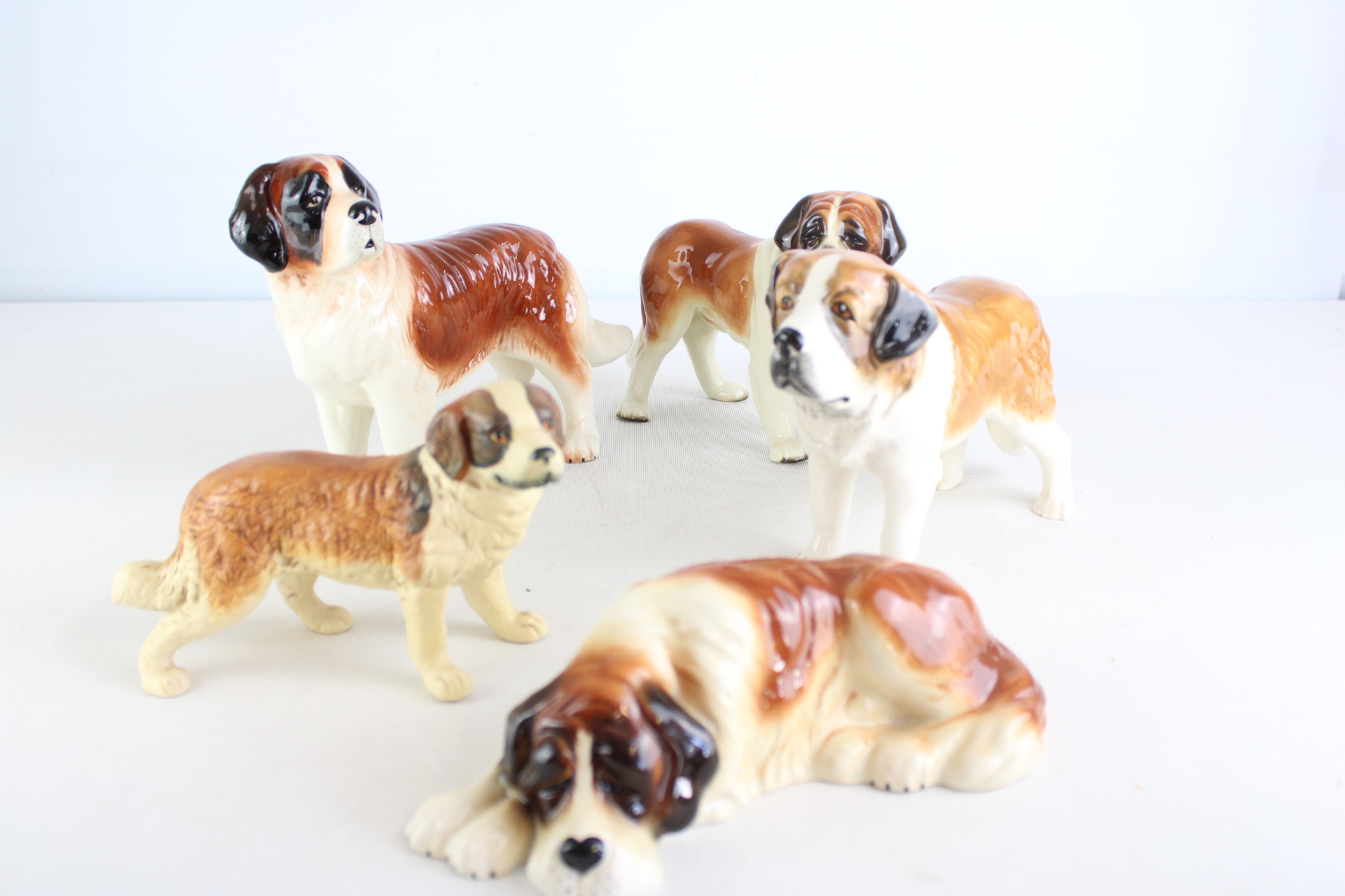 A Collection of Glazed Ceramic Saint Bernard Dog Figurines