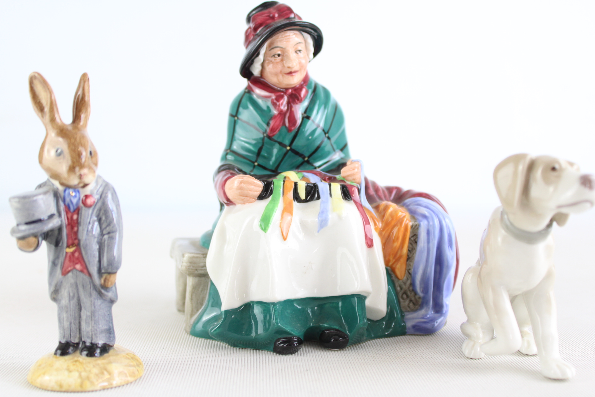 A Trio of Porcelain Figurines Including Royal Doulton Silks and Ribbons and a Beatrix Potter Gentleman Rabbit