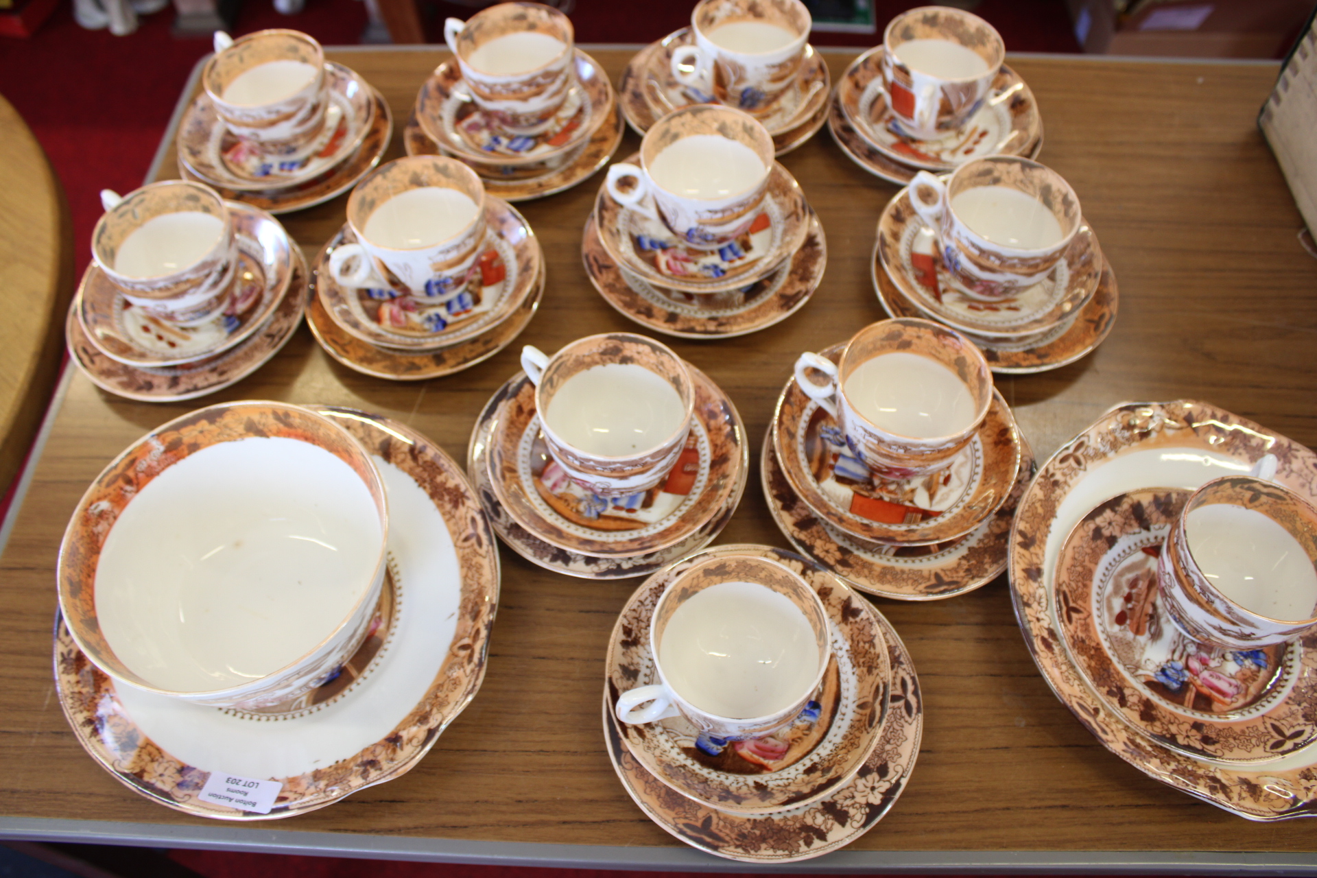 A Collection of Mid-19th Century Staffordshire Porcelain Tea and Coffee Wares with Copper Luster and Hand-Painted Genre Scenes
