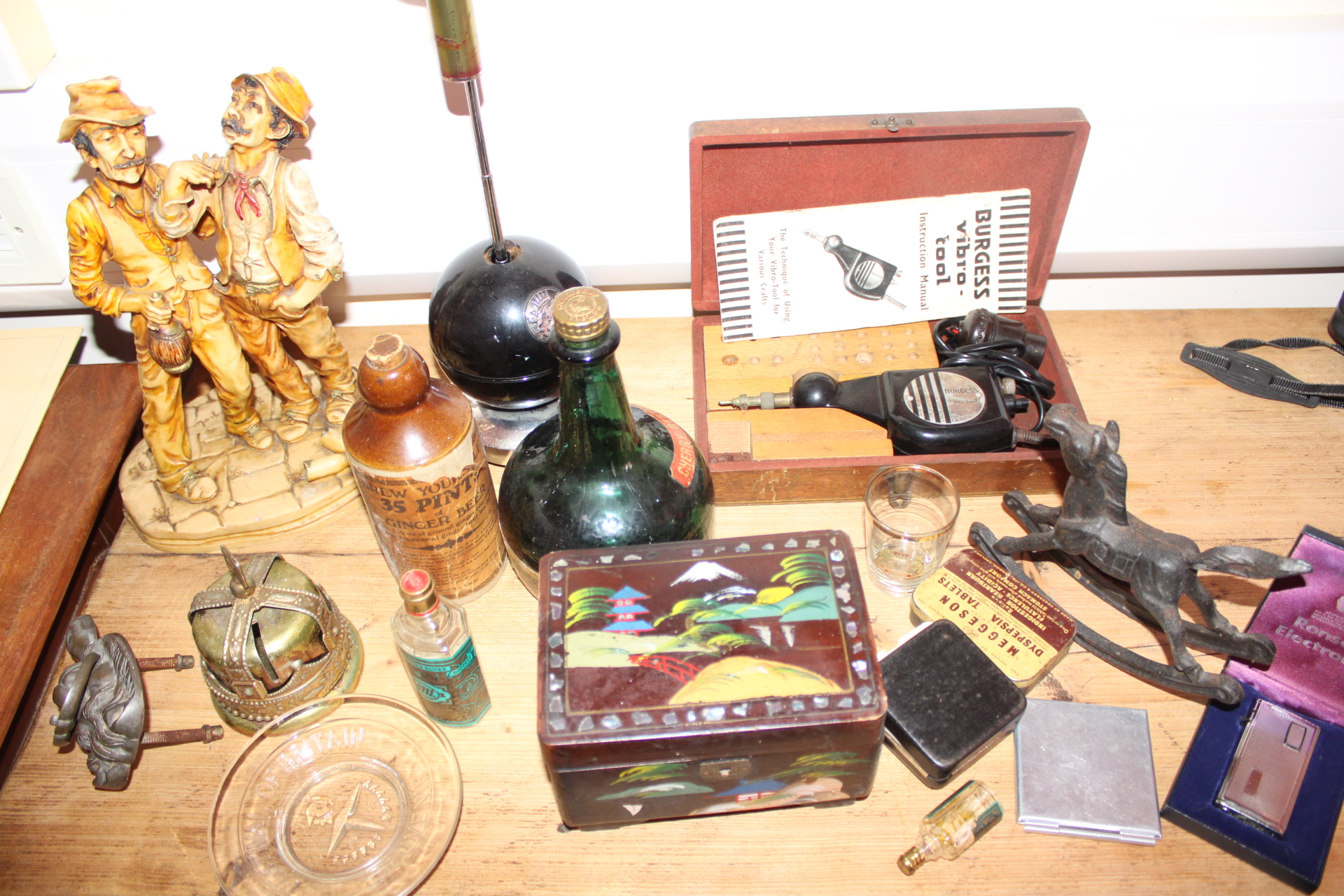 An Assortment of Vintage Collectibles Including Burgess Vibro-Tool, Stoneware Ginger Beer Bottle, and Ronson Lighter