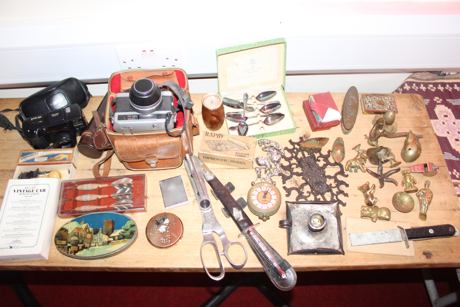 An Assortment of Vintage Collectibles Including Carl Zeiss Jena Werra and Konica Cameras, Militaria, and Decorative Items