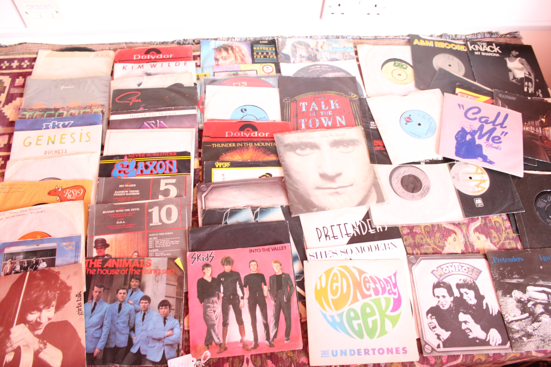 A Collection of Approximately 25 Vintage 7-Inch Vinyl Singles Featuring Blondie, Genesis, and The Animals