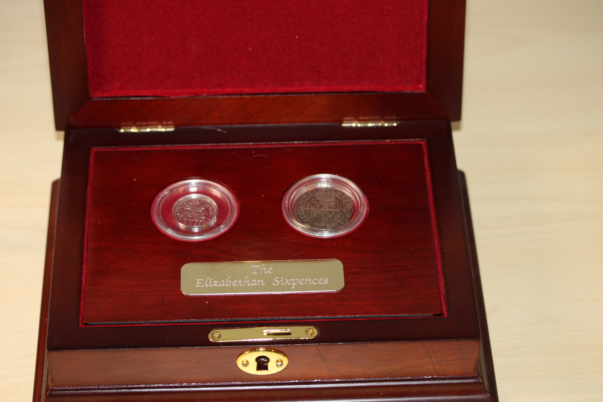 The Elizabethan sixpences in presentation case with coa