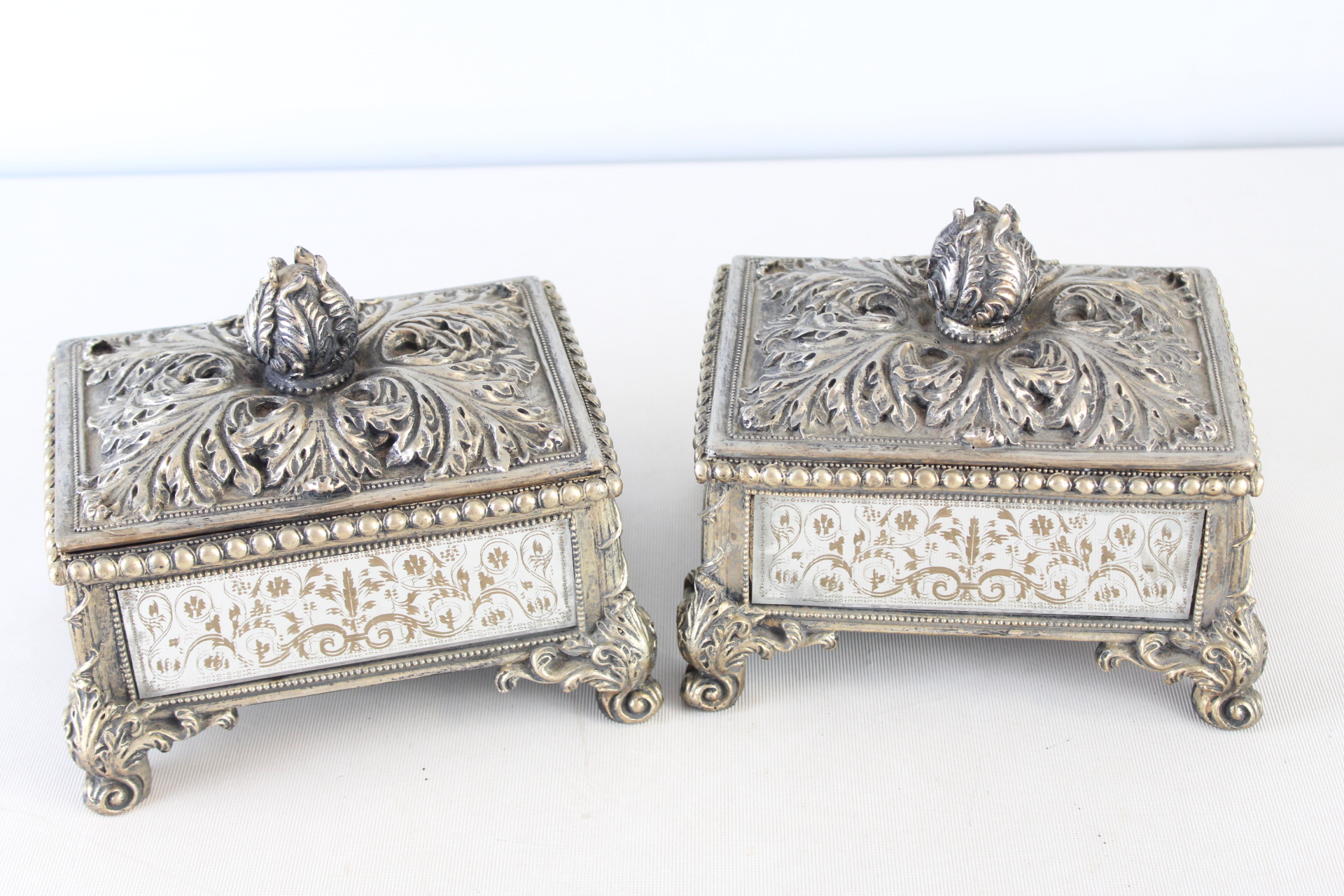 A Pair of Ornate Silver-Tone and Mirrored Glass Jewelry Boxes