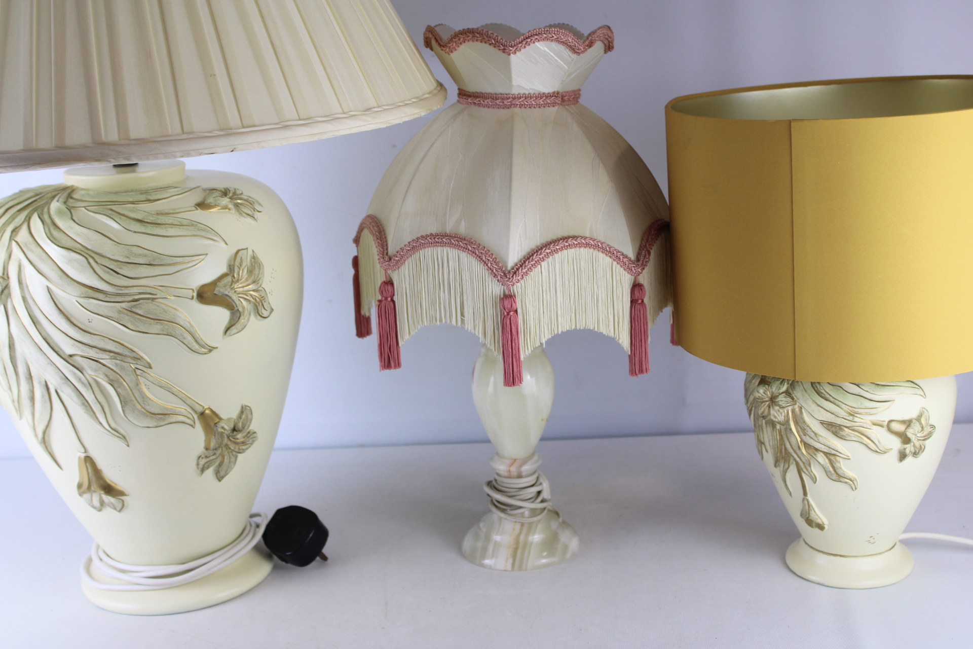 A Trio of Decorative Table Lamps Including a Pair of Relief-Molded Ceramic Bases and an Alabaster Base