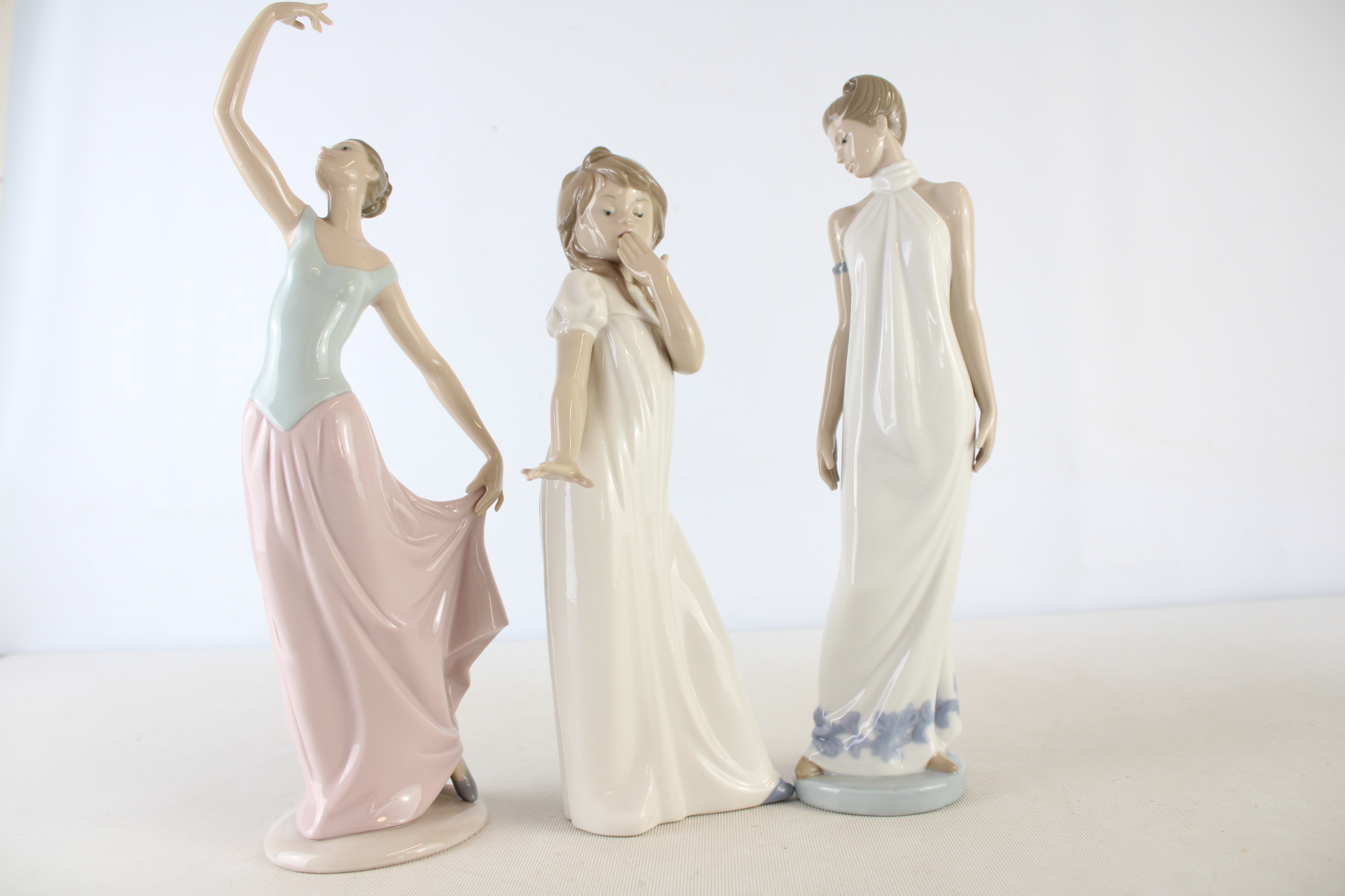A Trio of Nao by Lladro Glazed Porcelain Female Figurines