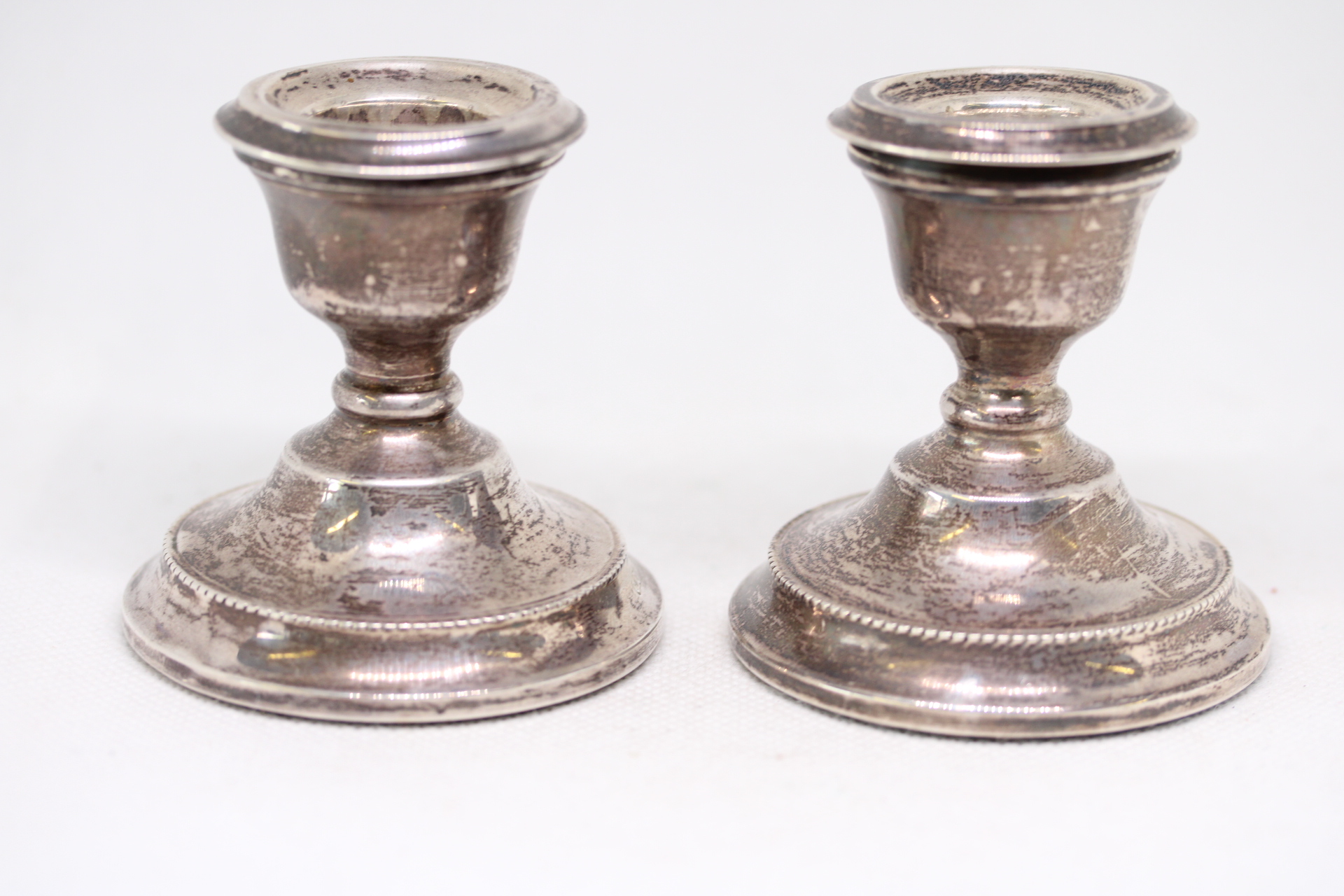 Pair of silver dwarf candle sticks - Loaded