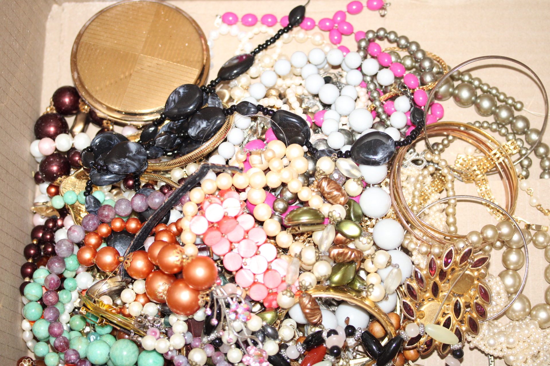 Large unsorted box of costume jewellery