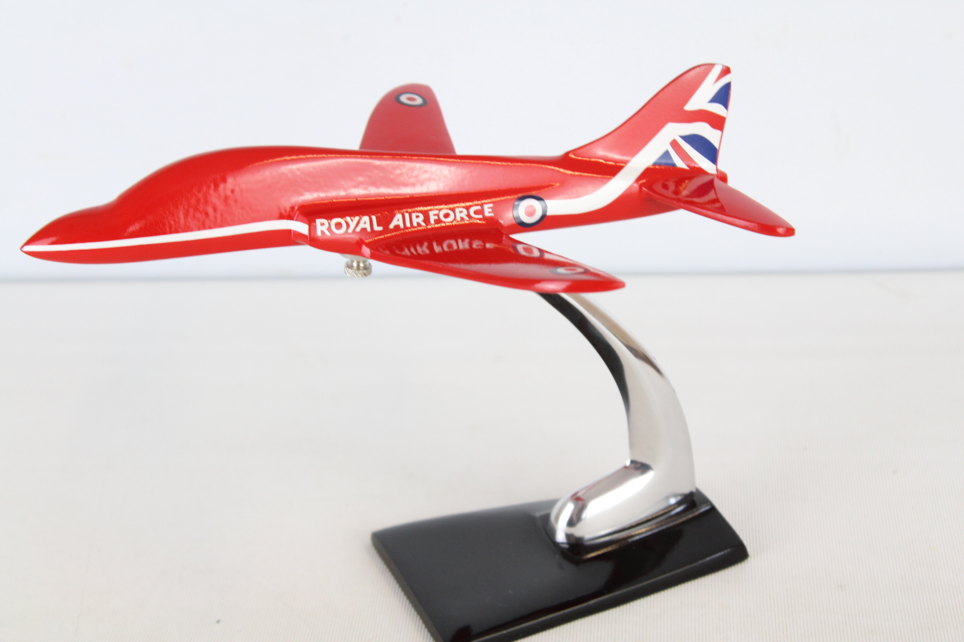 Metal red arrow plane on stand