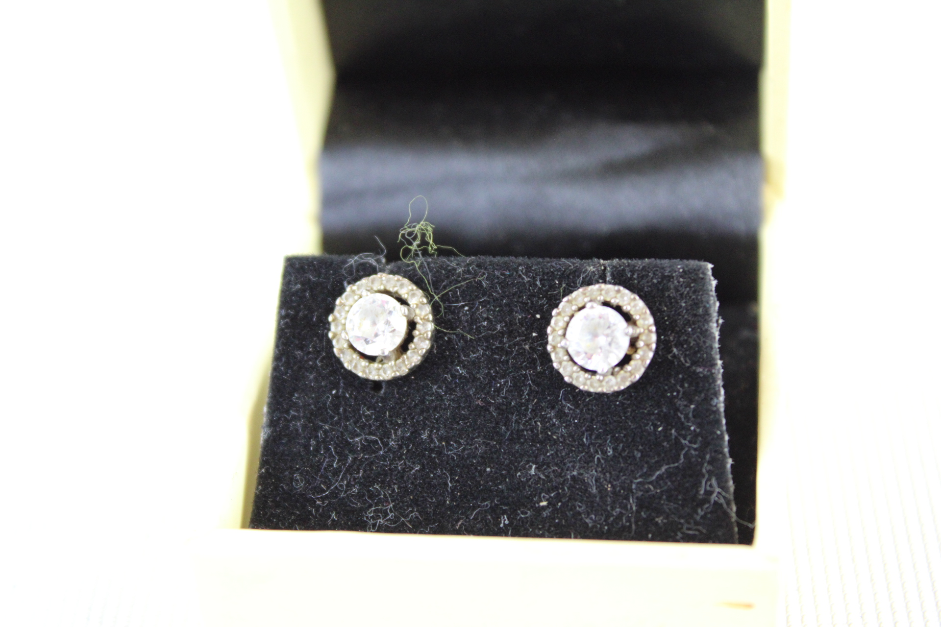 Boxed pair of silver soliatre earrings