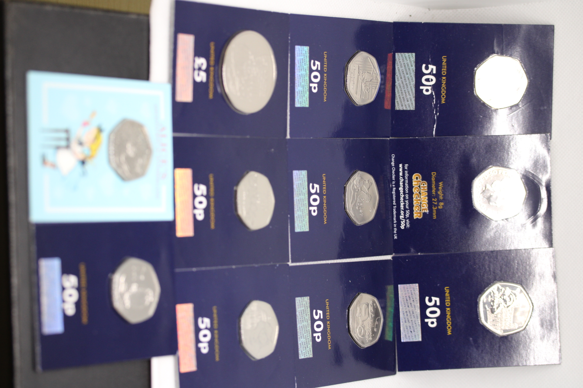 Collection of change checker coins- 10x 50p coins & 1x 5 pound coin