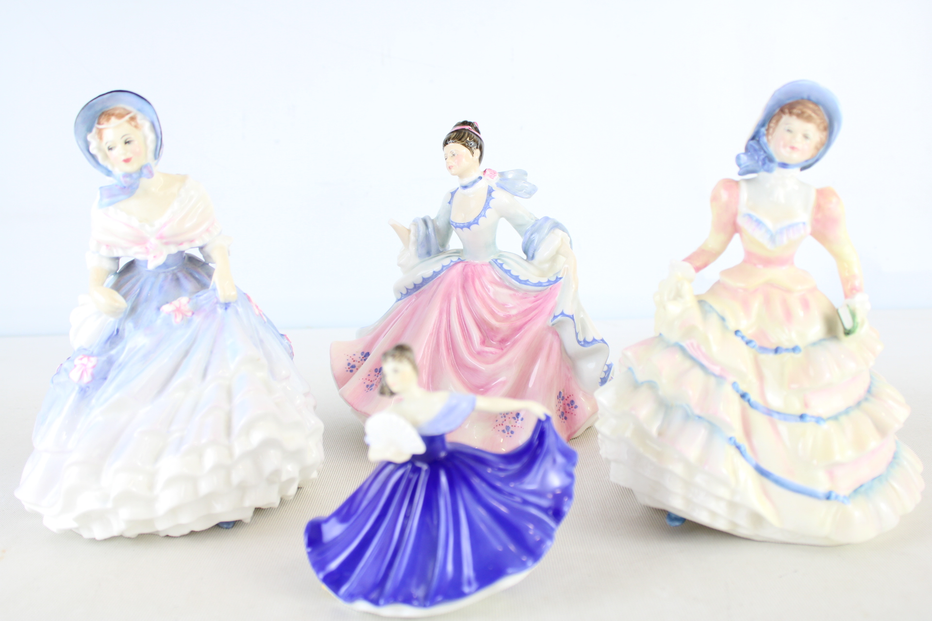 A Set of Four Late 20th Century Glazed Porcelain Lady Figurines