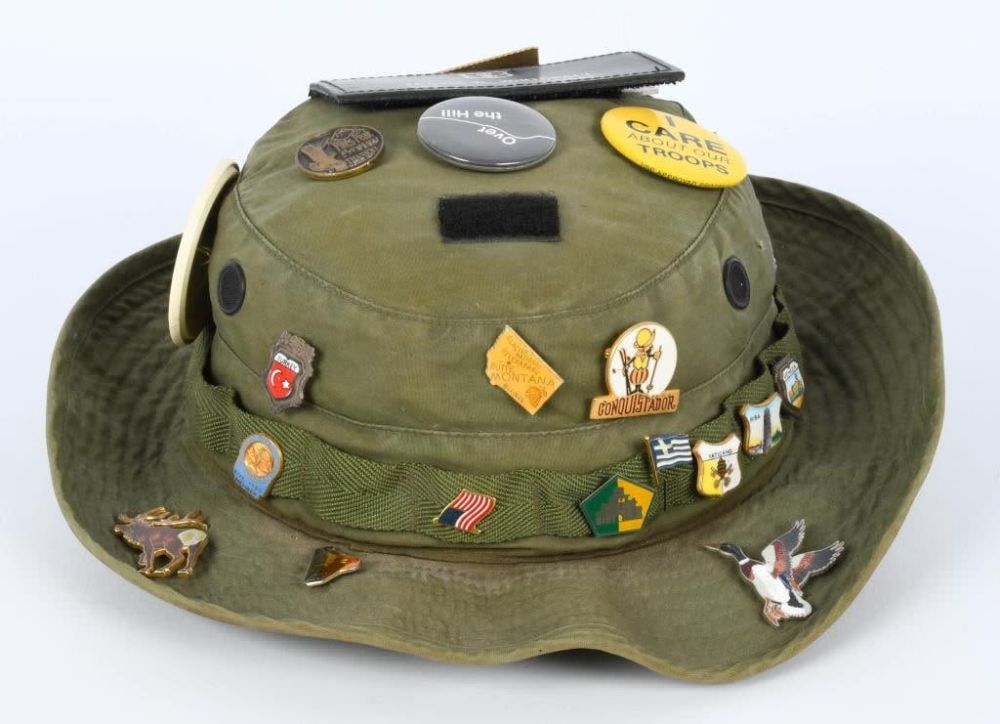 Lot 92: OD green Military hat with various vintage pins