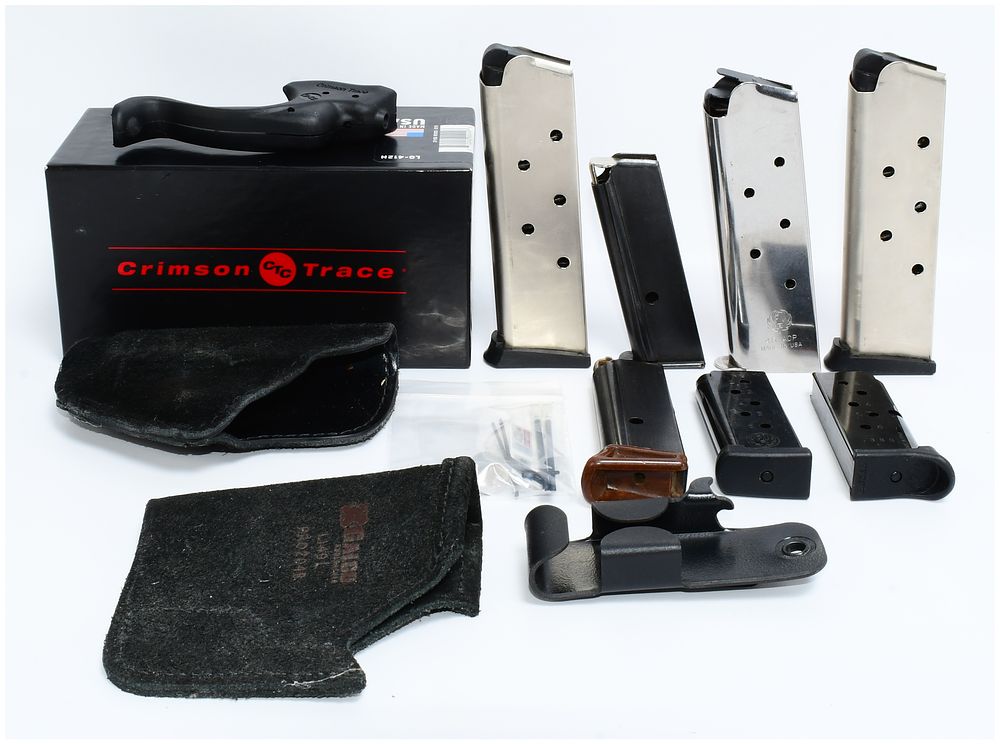 Lot 473: A Collection of Modern Firearm Accessories, including a Crimson Trace LG-412H Laser Grip, Magazines, and Holsters