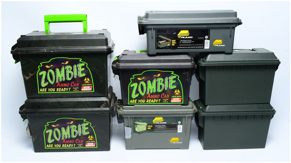 Lot 1325: A Collection of Seven Plano and MTM Plastic Storage Containers, including 'Zombie Ammo Cans,' Shot Shell Boxes, and Field Boxes