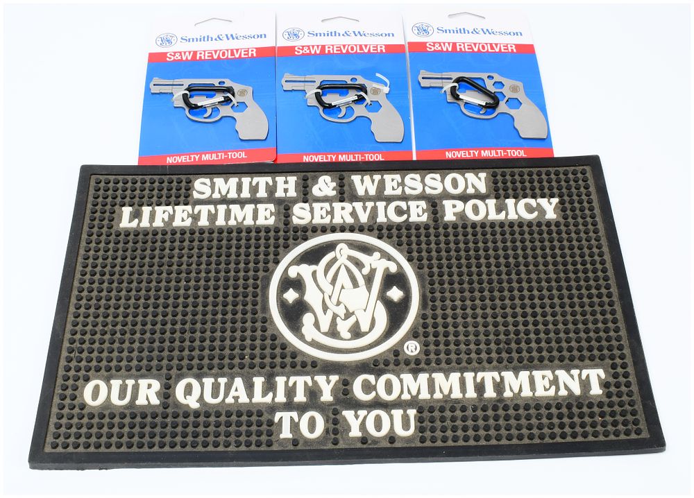 Lot 1337: Three Smith & Wesson S&W Revolver Novelty Multi-Tools and a Smith & Wesson Lifetime Service Policy Rubber Counter Mat