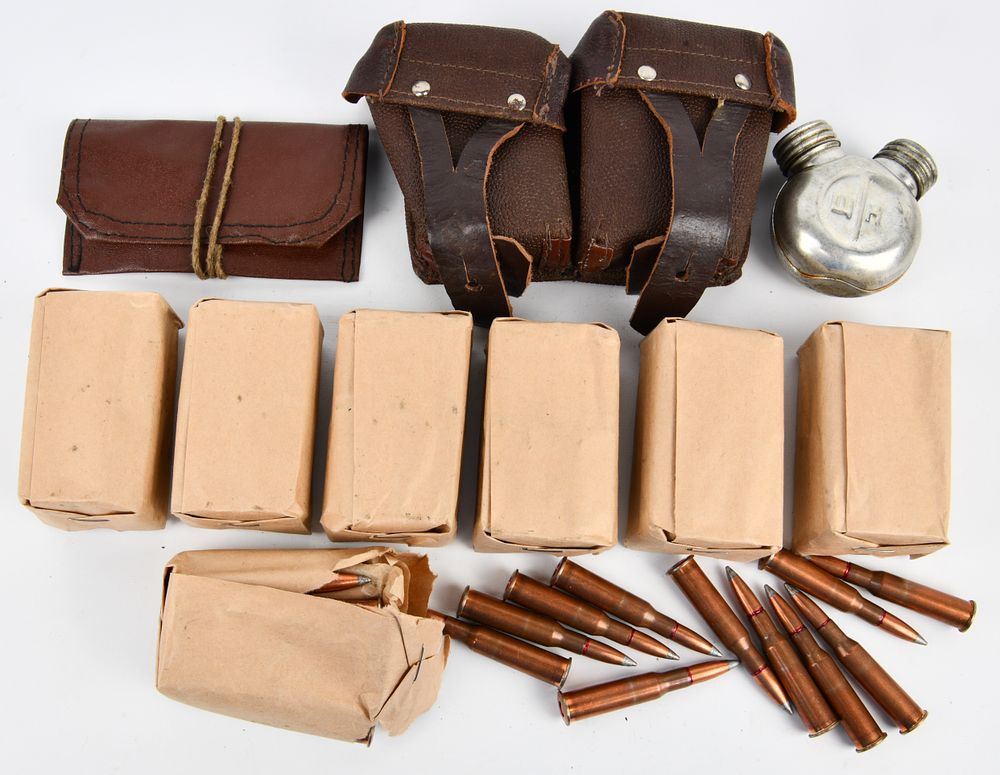 Lot 281: A Collection of Vintage Mosin Nagant 7.62x54r Ammunition, Pouches, and Oil Can