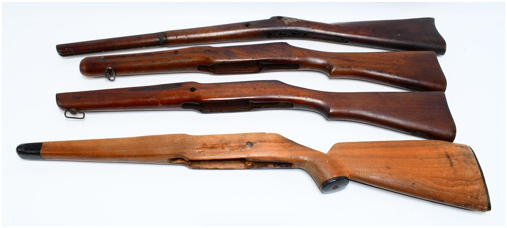 Lot 586: A Group of Four Assorted Rifle Stocks, including Military and Sporterized Wood Examples, and one Synthetic Stock