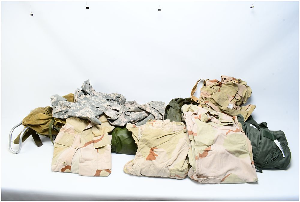 Lot 1570: A Collection of US Military Desert Camouflage Uniform (DCU) Components, CWU27/P Flyers Coveralls, and Field Gear