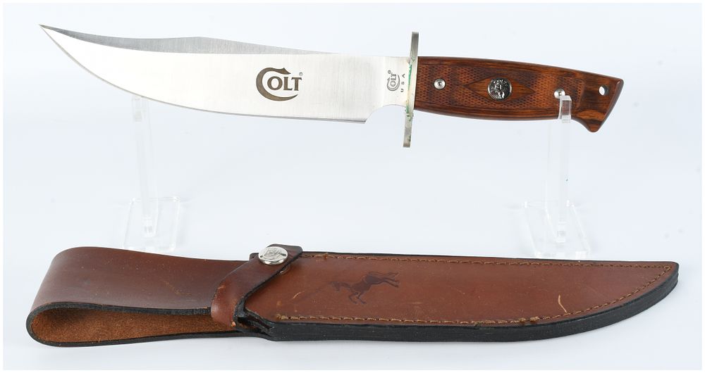 Lot 467: A Colt CT1 USA Vintage Bowie Knife with Checkered Wood Handle and Leather Sheath