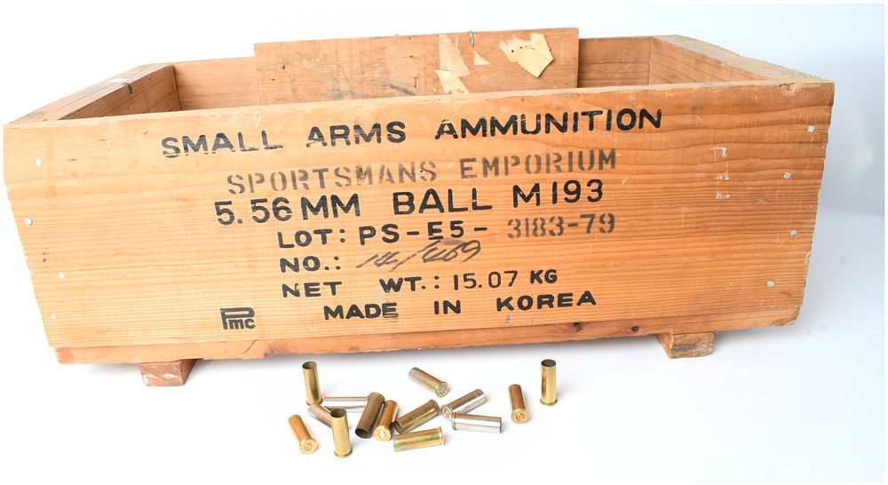 Lot 460: A Bulk Lot of Spent .38 Special Brass and Nickel Cartridge Casings in a PMC 5.56mm Ammunition Wood