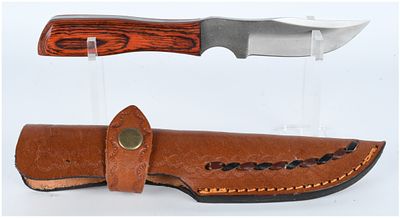 A Fixed Blade Knife with Serrated Spine and Custom Leather Sheath. This lot consists of two 