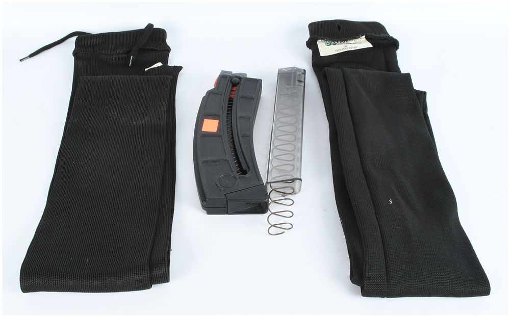 Lot 1241: A Lot of 4 Firearm Accessories: Smith & Wesson .22 LR Magazine, ETS 9mm Magazine, and Two Gunsock Sleeves