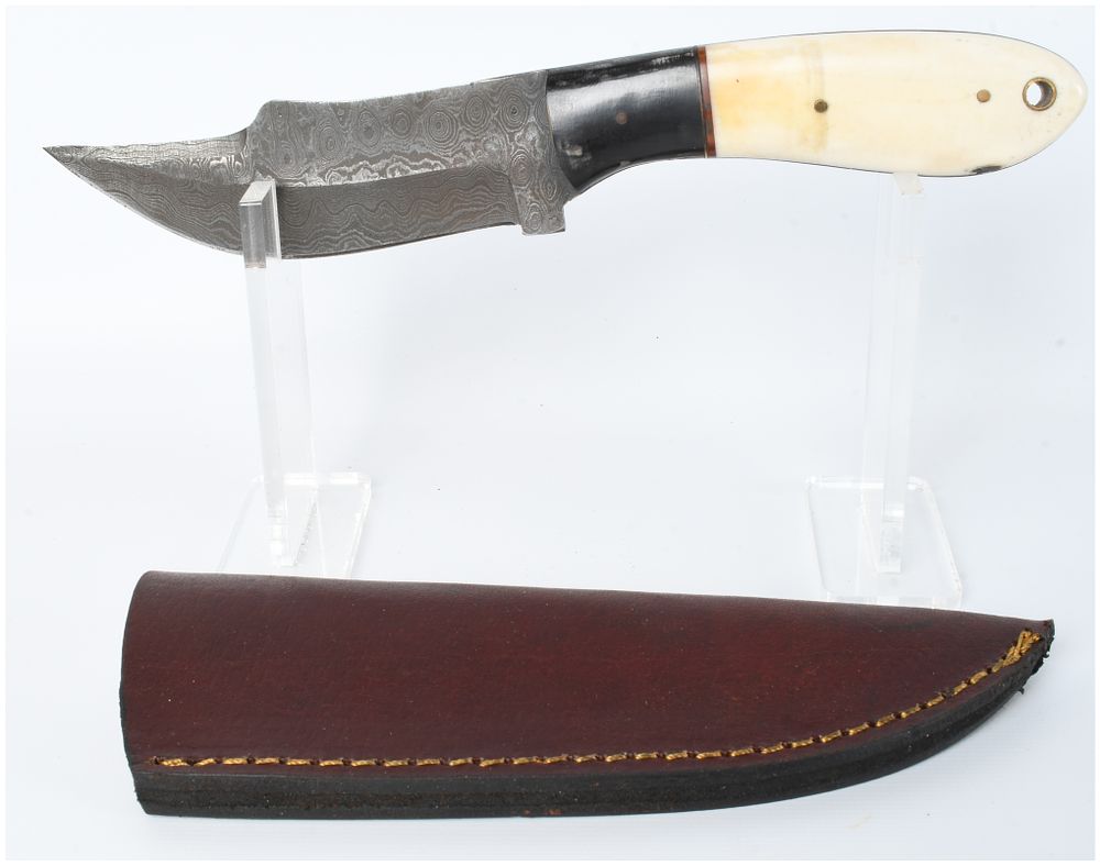 Lot 1300: A Damascus Steel Skinning Knife with Bone and Horn Style Handle