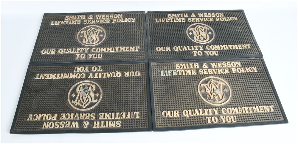 Lot 59: A Collection of 4 Smith & Wesson Lifetime Service Policy Rubber Counter Mats