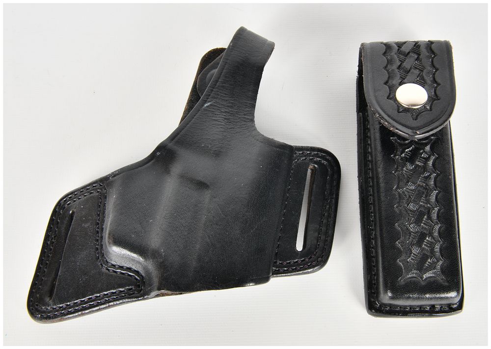 Lot 383: A Pair of Black Leather Accessories Including a Bianchi Model 5 Holster and a Safariland Magazine Pouch