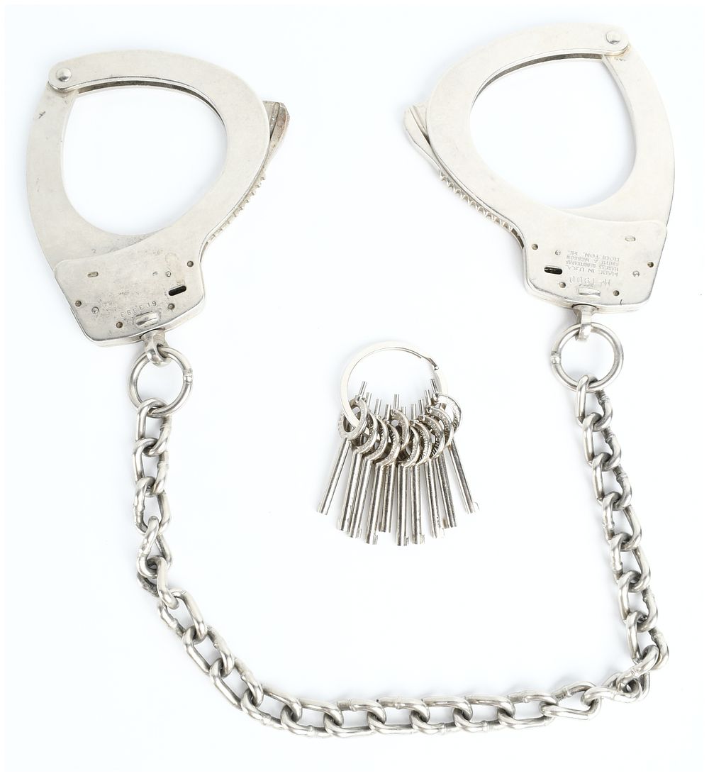 Lot 416: A Pair of Smith and Wesson Model M-1900 Leg Irons and a Collection of Peerless Handcuff Keys