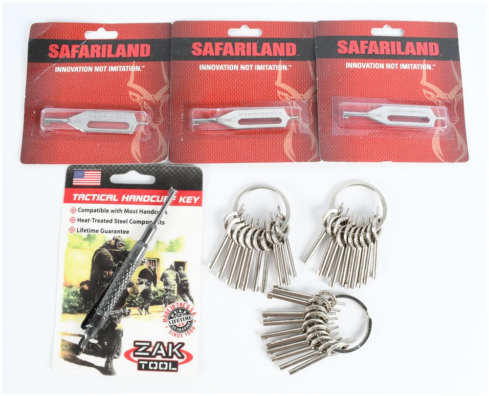 Lot 536: A Collection of 38 Safariland, Peerless, and Zak Tool Handcuff Keys and Tactical Tools