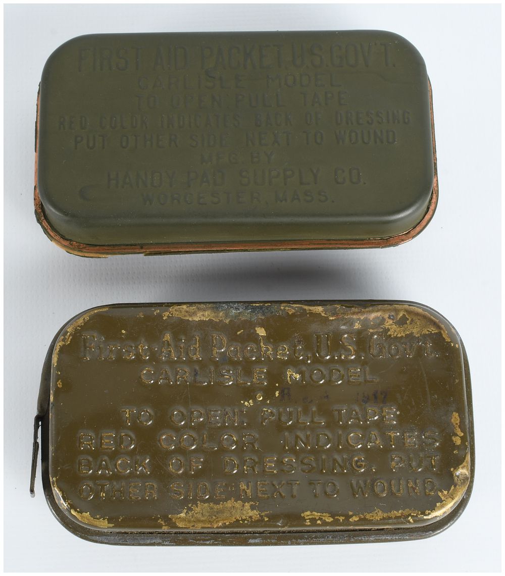 Lot 389: Two US Army Carlisle Model First Aid Packets, WWI and WWII Eras