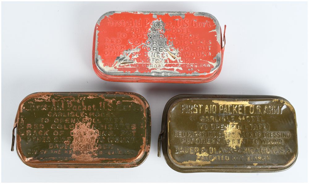 Lot 479: Trio of WWII US Army Carlisle Model First Aid Packets by Bauer and Black