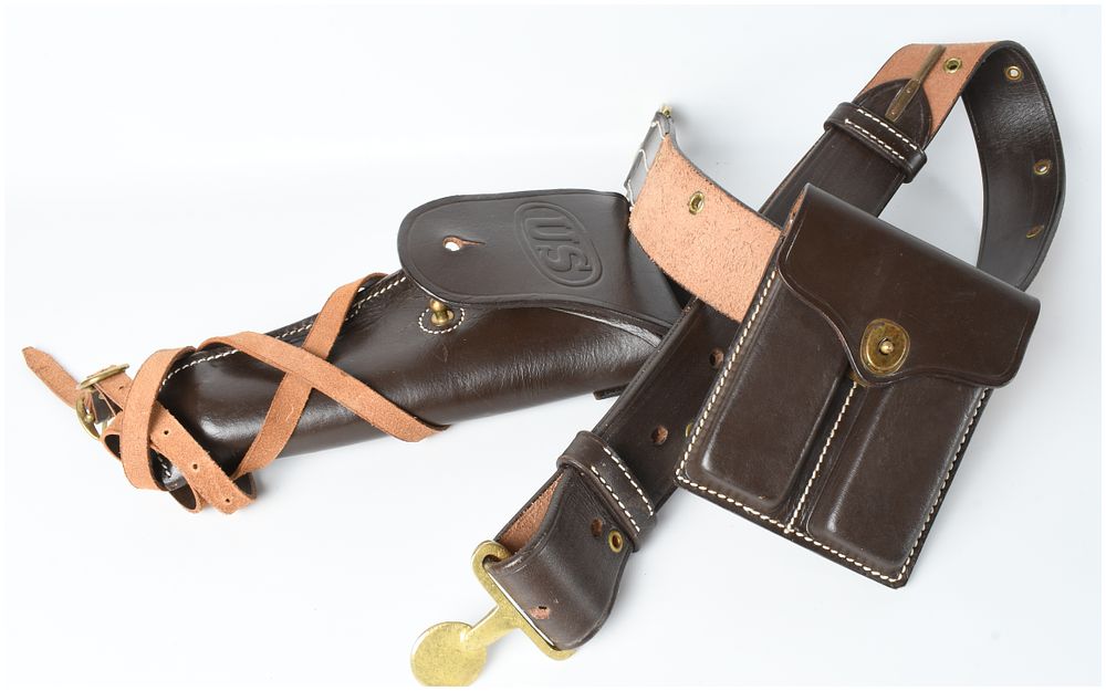 Lot 620: Three replica US Army leather equipment items including an officer-style belt, M1911 holster, and magazine pouch