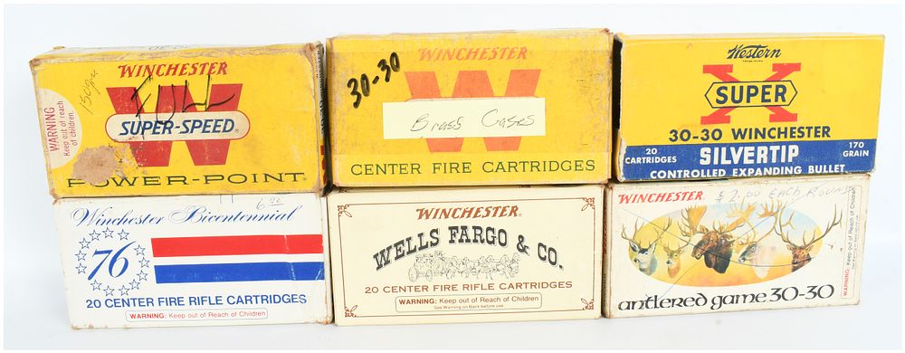 Lot 556: A Collection of 25 Live Rounds and 58 Empty .30-30 Winchester Casings for Reloading