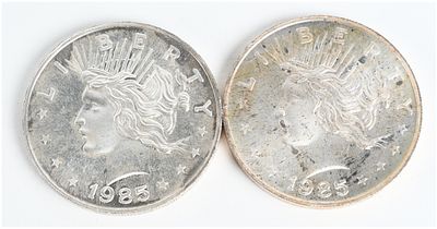 A Pair of 1985 Peace Dollar Design 1 Troy Ounce .999 Fine Silver Trade Units. This lot consists 