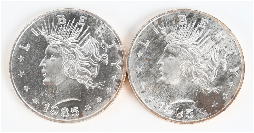 Lot 1097: A Pair of 1985 Peace Dollar Design 1 Troy Ounce .999 Silver Trade Units