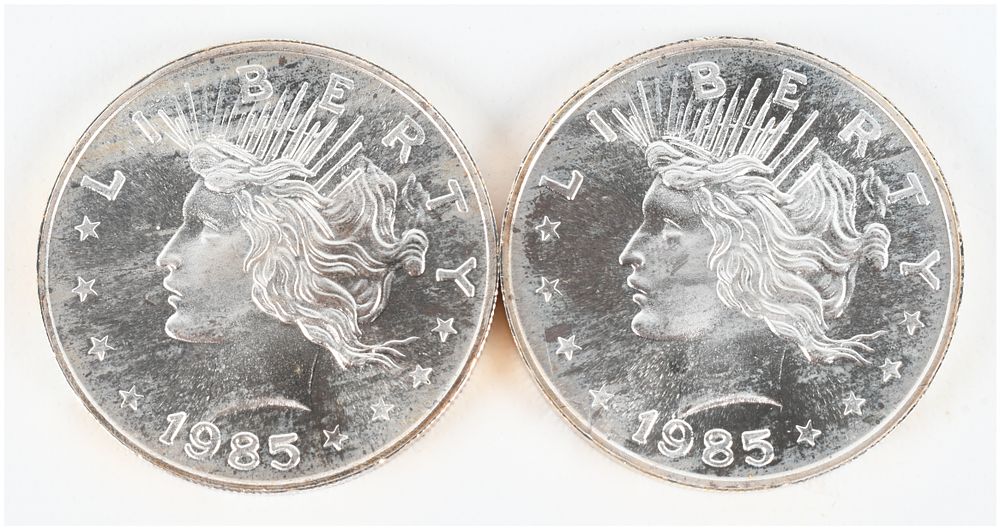 Lot 1217: A Pair of 1985 Peace Dollar Design 1 Troy Ounce .999 Fine Silver Trade Units