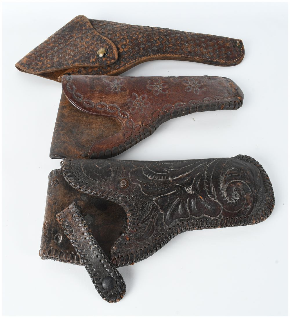 Lot 77: Three Tooled and Carved Leather Handgun Holsters