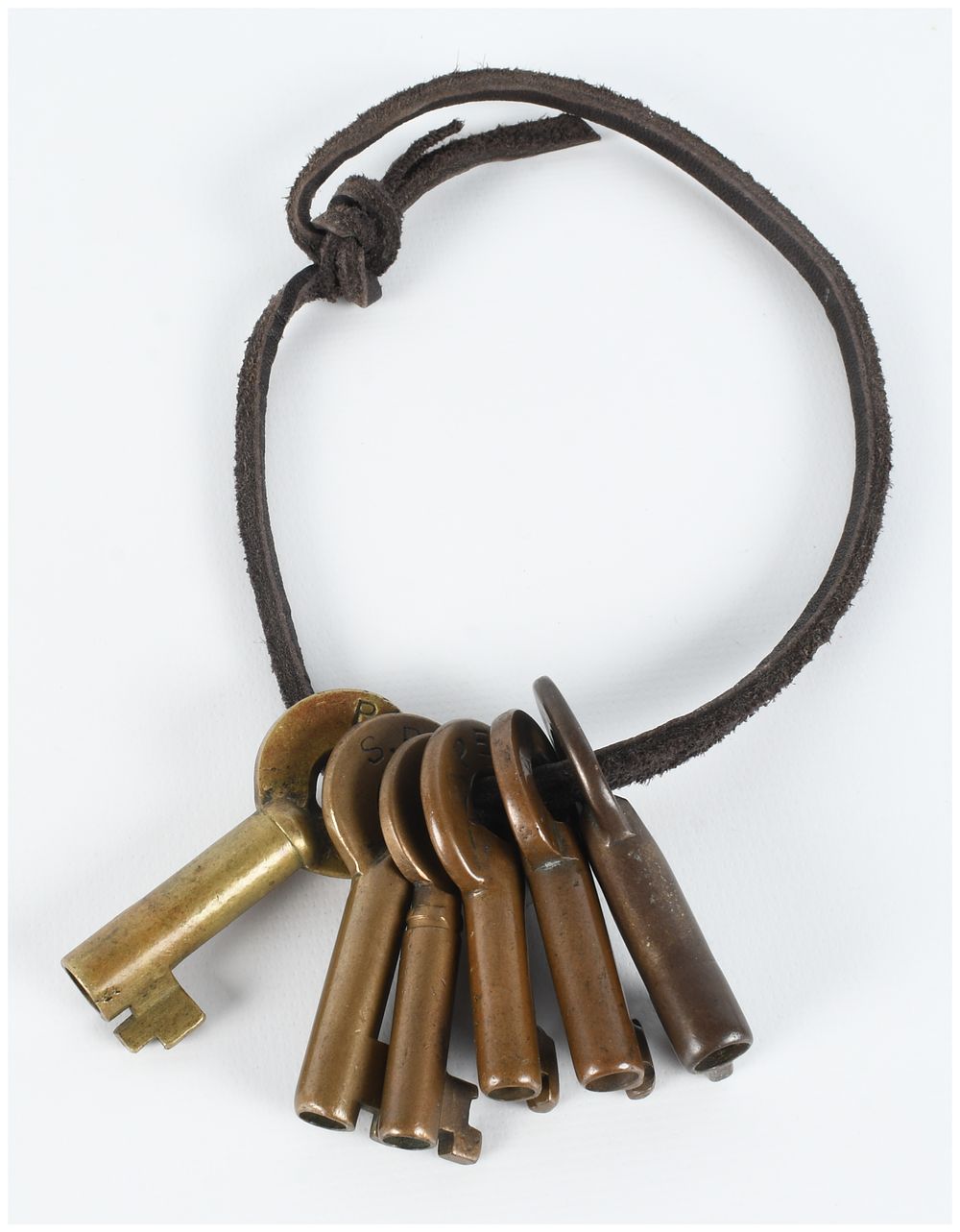 Lot 194: Set of 6 Antique Perry and Co Cast Brass Barrel Keys on Leather Cord