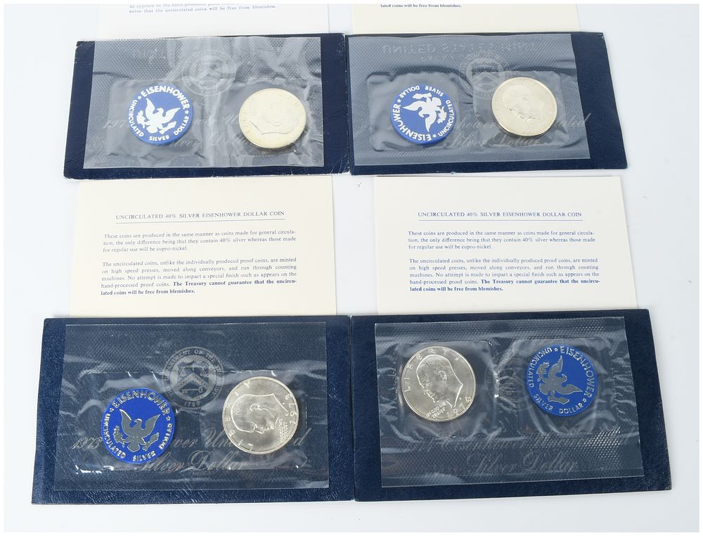 Lot 1229: A Group of Four US 1971-S to 1974-S Eisenhower Silver Dollars Blue Pack Uncirculated