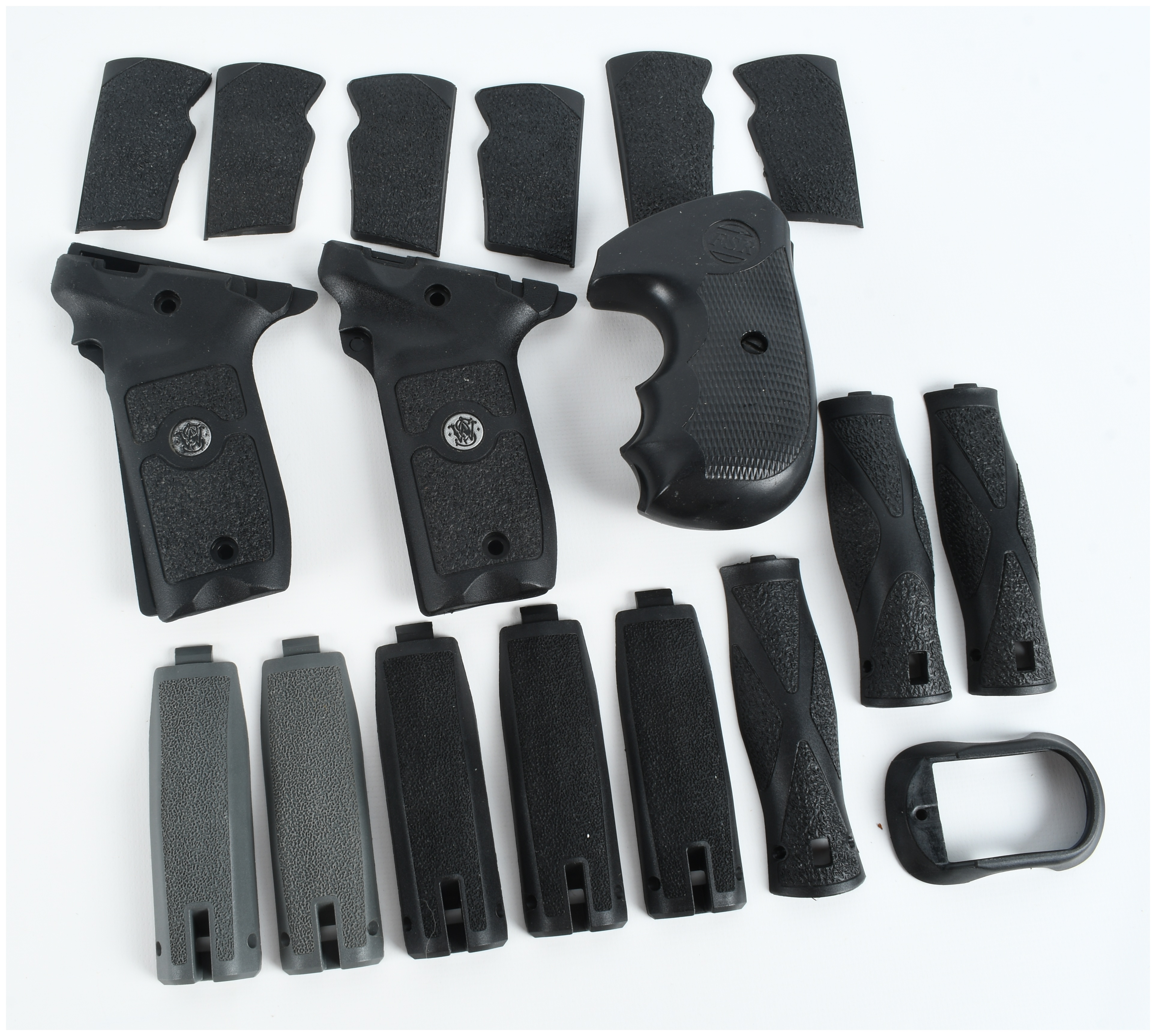 A Collection of 4 Smith & Wesson and FSR Handgun Grips and Backstrap Components