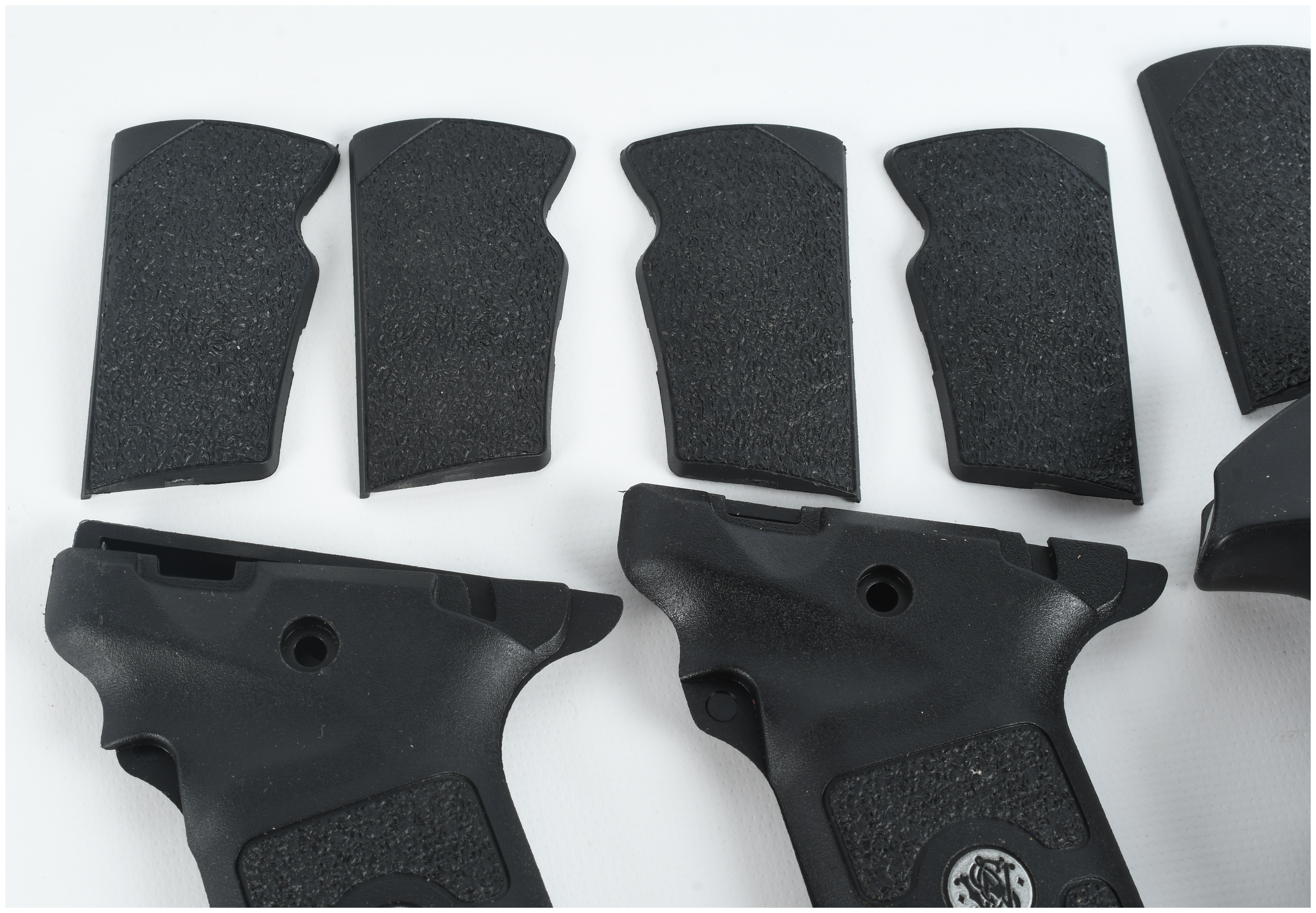 A Collection of 4 Smith & Wesson and FSR Handgun Grips and Backstrap Components