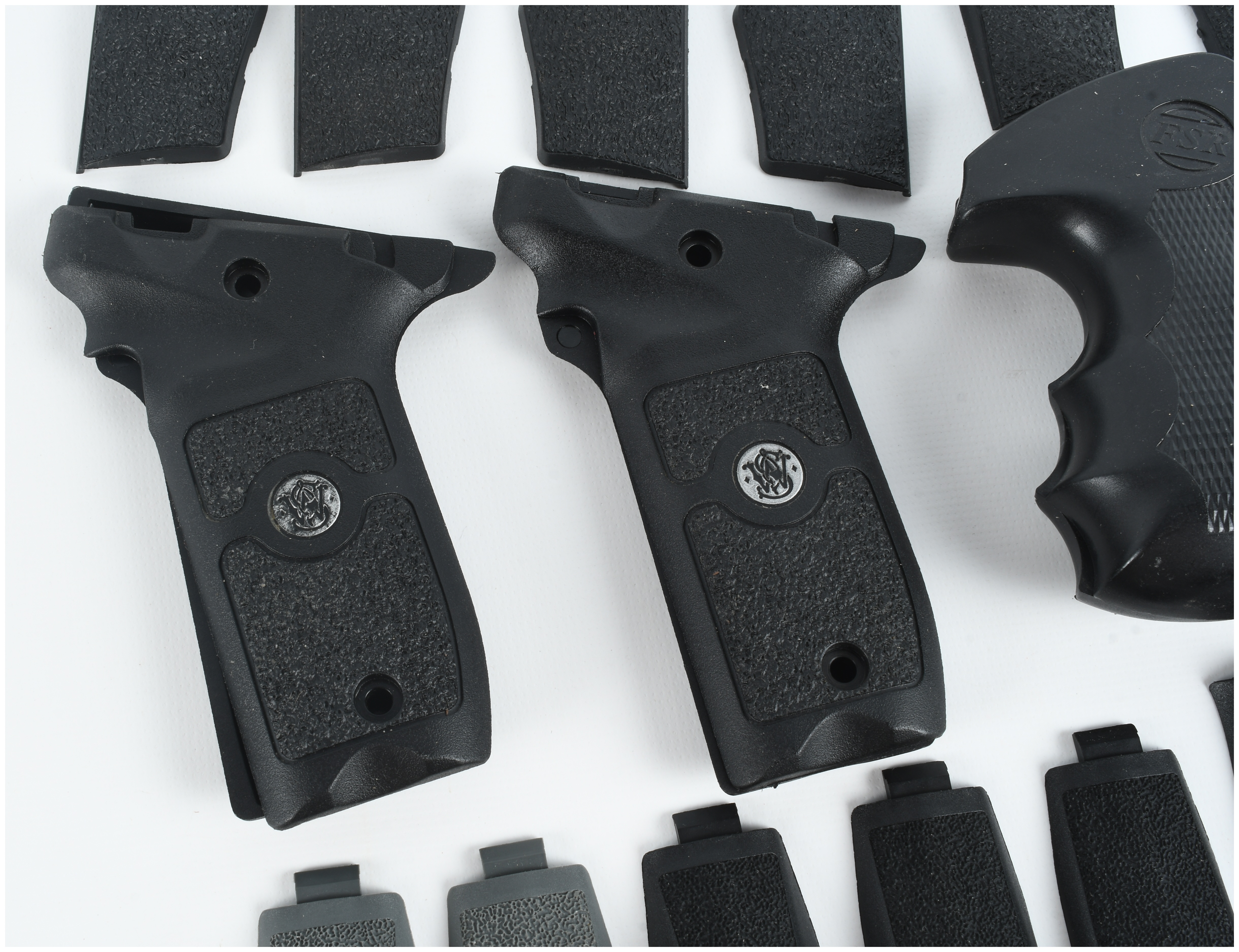 A Collection of 4 Smith & Wesson and FSR Handgun Grips and Backstrap Components