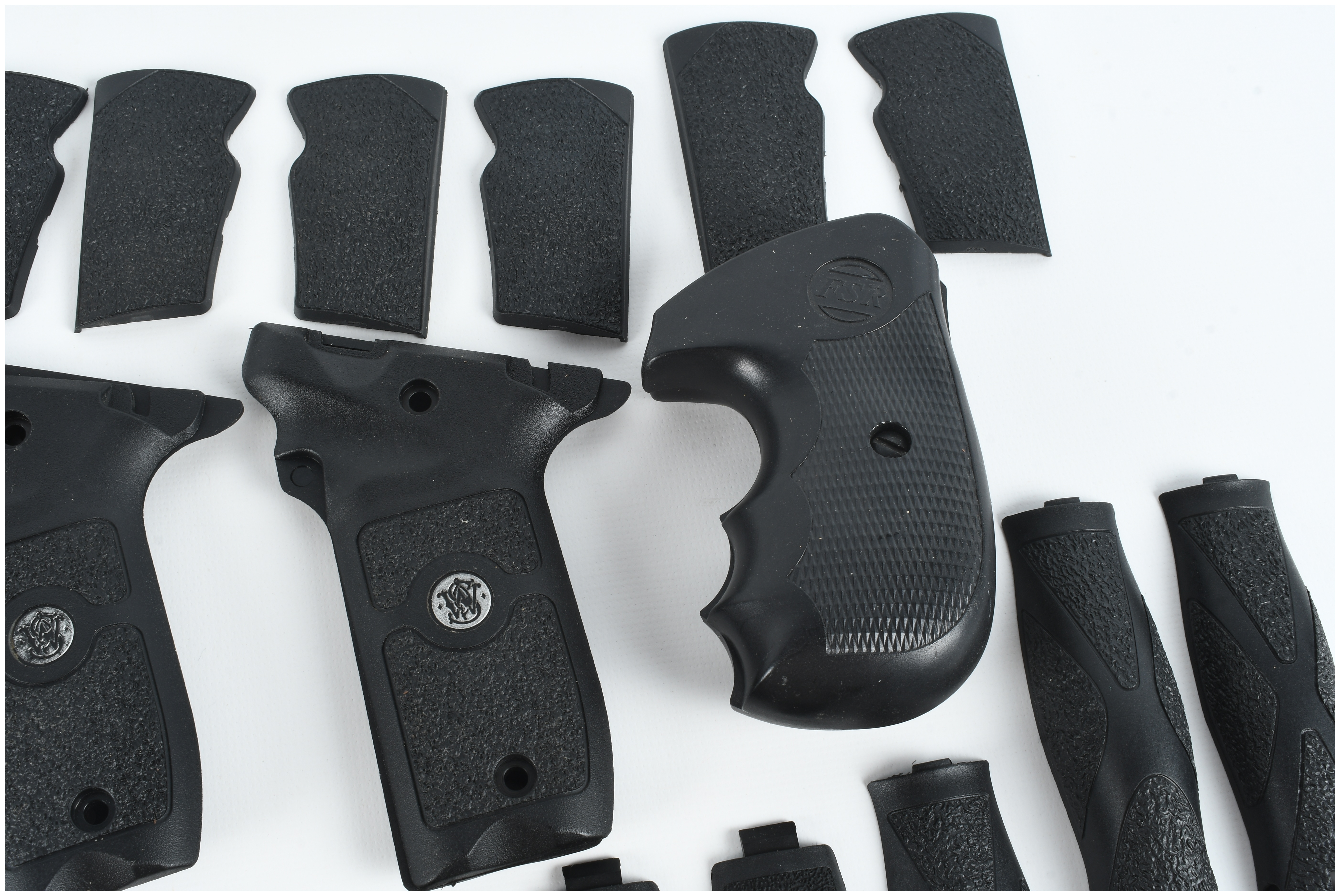 A Collection of 4 Smith & Wesson and FSR Handgun Grips and Backstrap Components