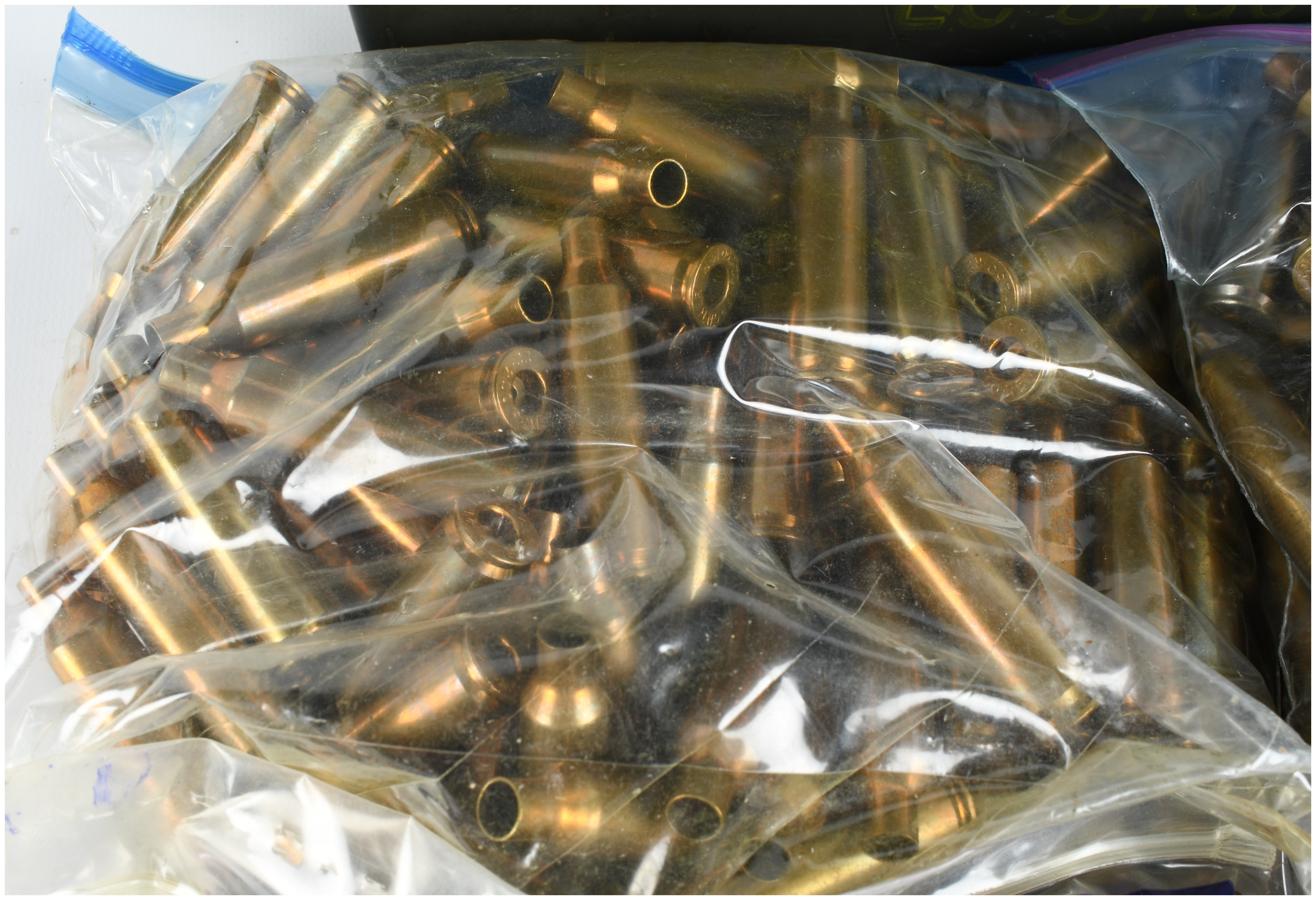 A Lot of 400 .22-250 Remington Caliber Brass Cartridge Cases and One Ammunition Can