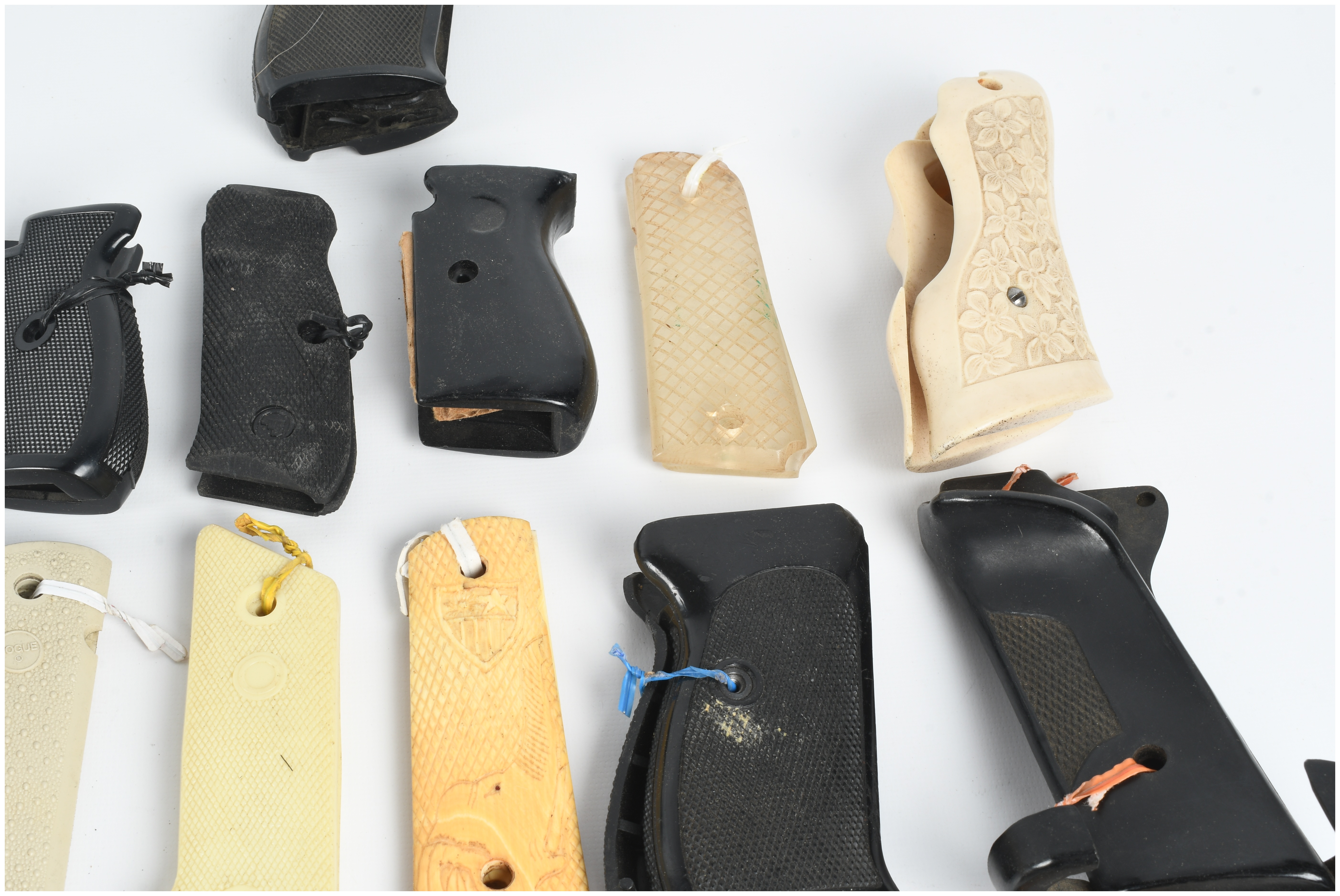 A Collection of 18 Assorted Handgun Grips and Accessories including Pearce Grip and Hogue Examples