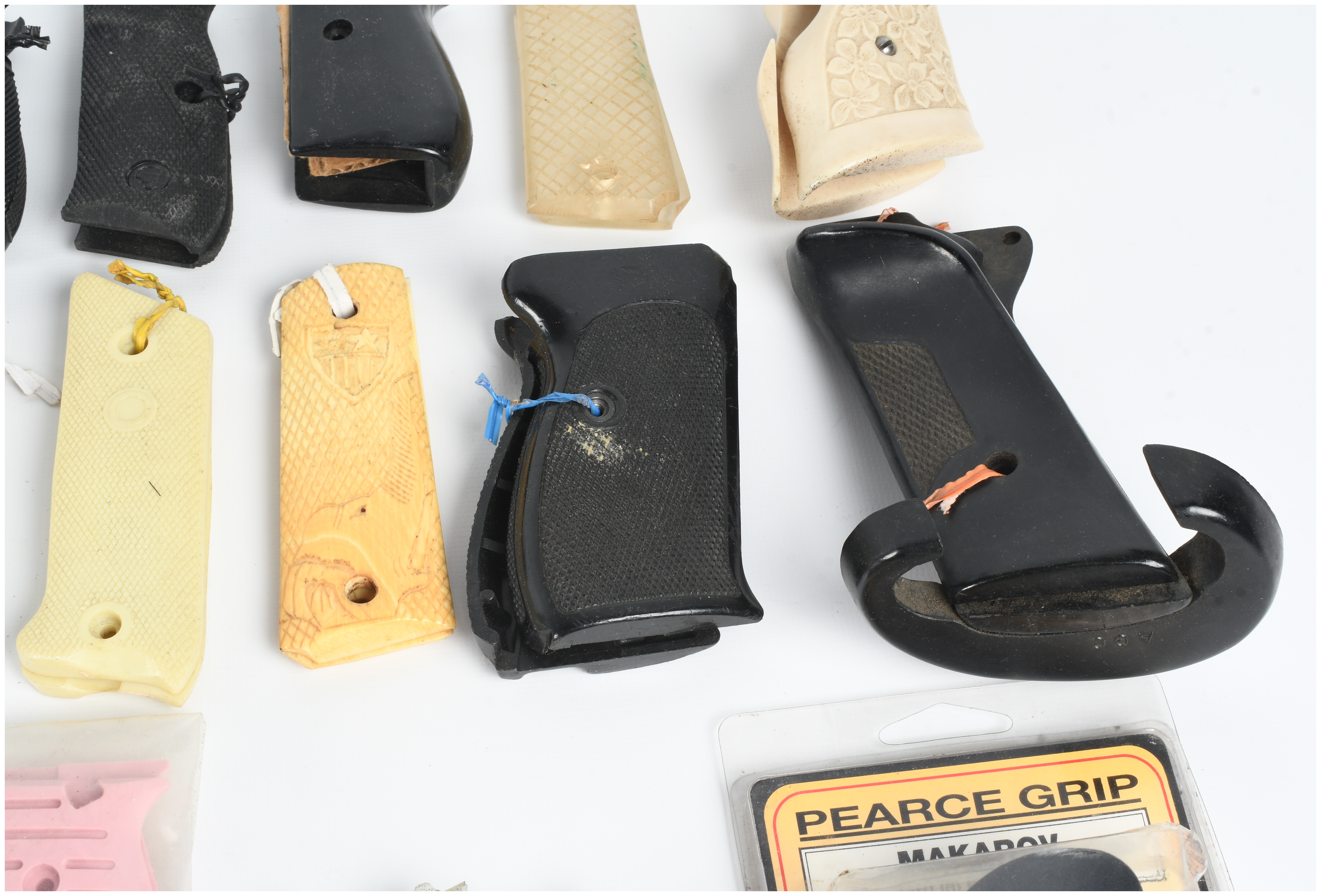A Collection of 18 Assorted Handgun Grips and Accessories including Pearce Grip and Hogue Examples