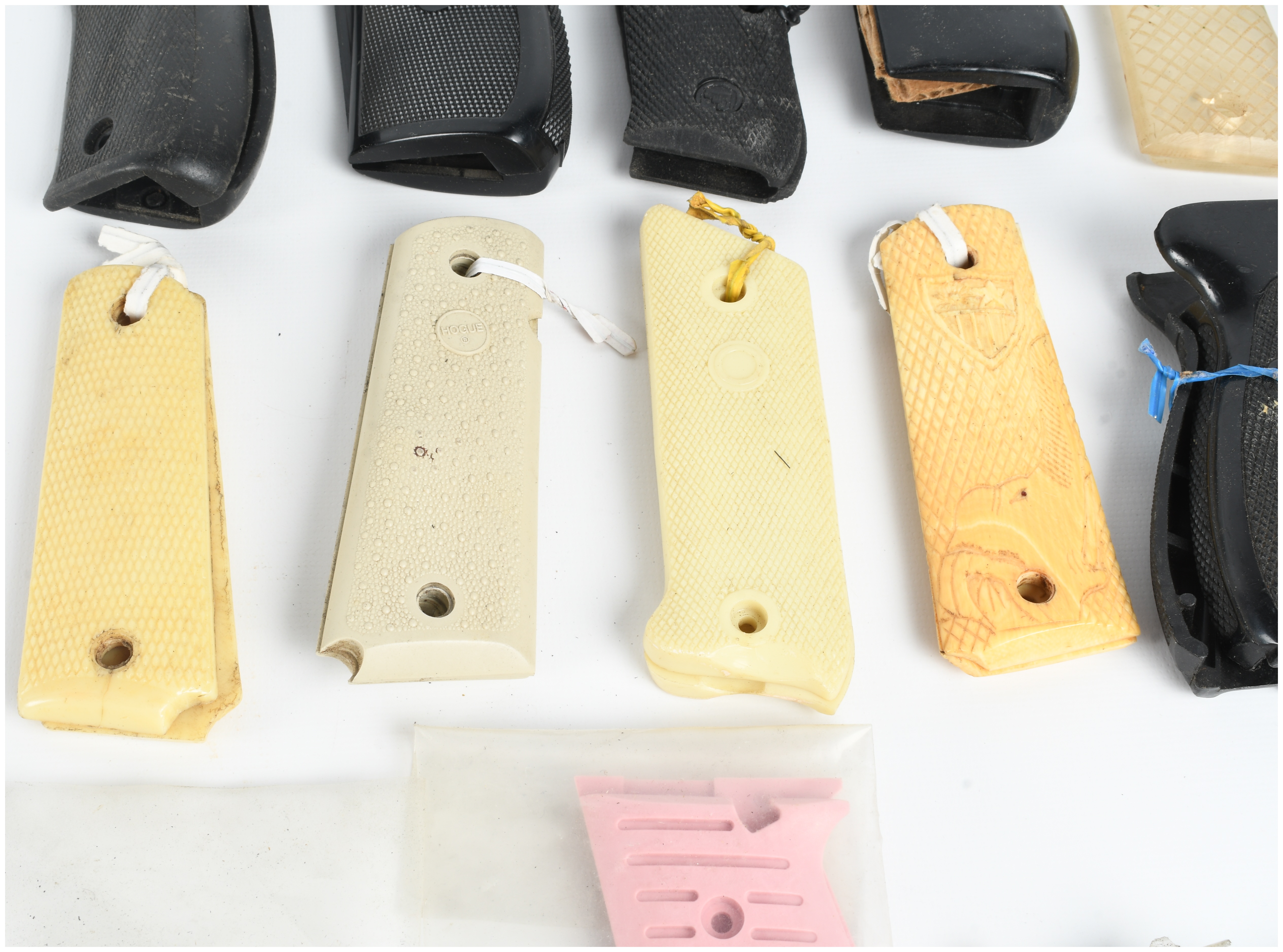A Collection of 18 Assorted Handgun Grips and Accessories including Pearce Grip and Hogue Examples